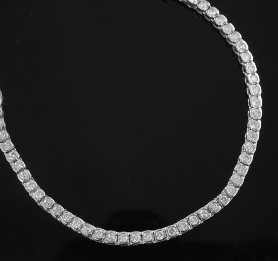 A modern 18ct white gold and diamond line bracelet. 17.5cm.